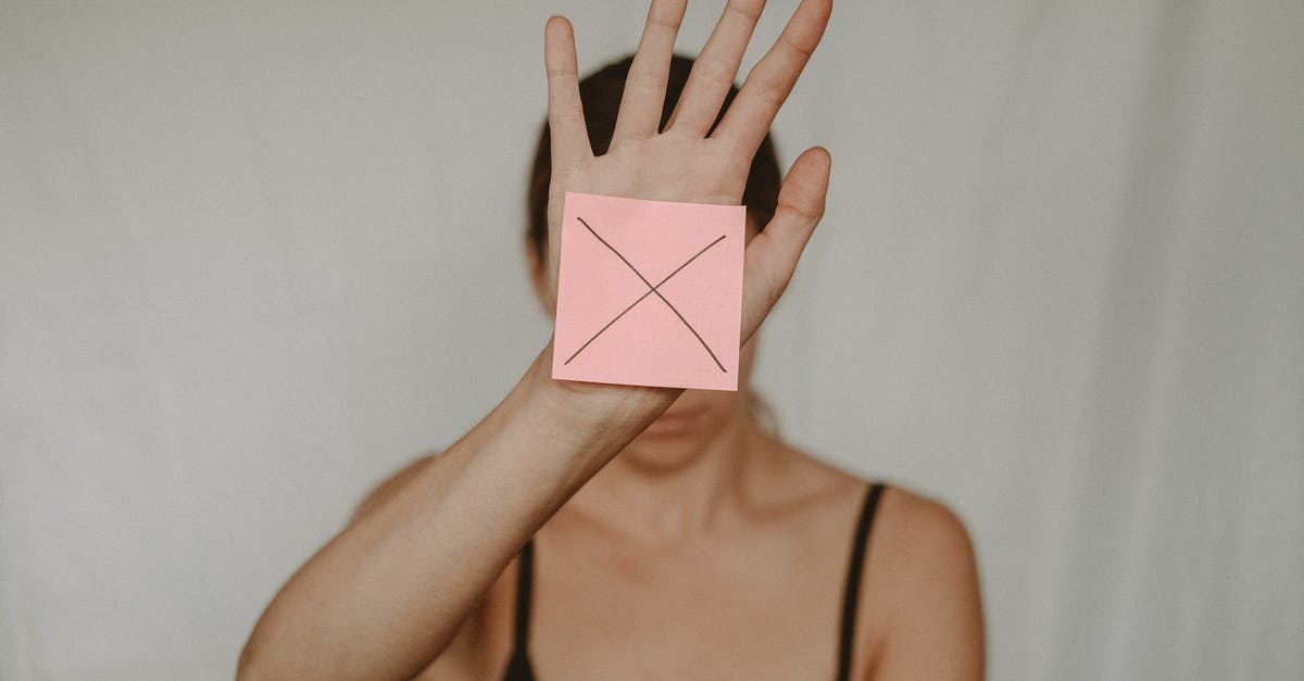 Assessing risk for UK visa refusal [closed] - Unrecognizable young woman demonstrating prohibition sign showing gesture of refuse using hand and note with sign stop