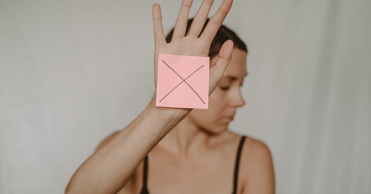 Assessing risk for UK visa refusal [closed] - Woman with paper with cross sign