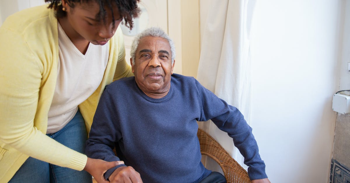 Assistance for an elderly non-revenue air passenger - Woman Assisting Elderly Man