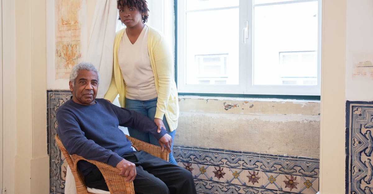 Assistance for an elderly non-revenue air passenger - Elderly Man Sitting Beside Woman by the Window