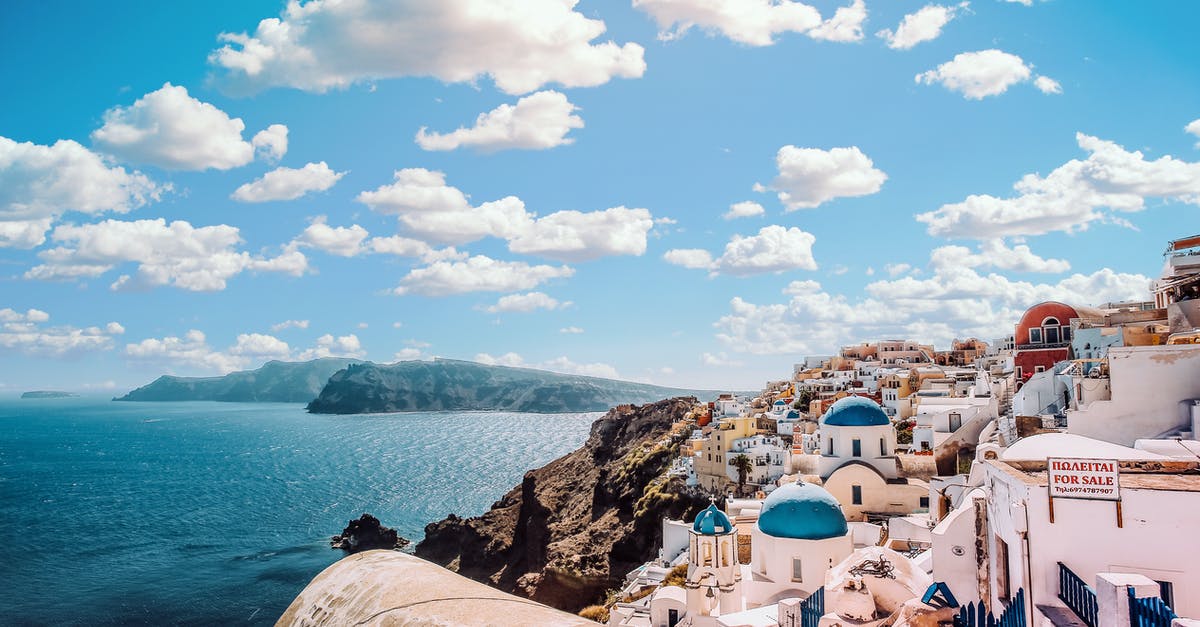 Athens to Santorini - White Concrete House Near Body of Water Under White and Blue Cloudy Sky