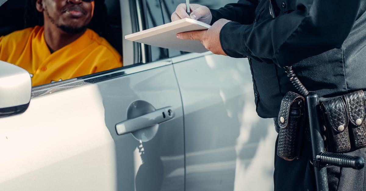 Australia ETA with prior speeding ticket - Man Looking at the Police Officer Writing 