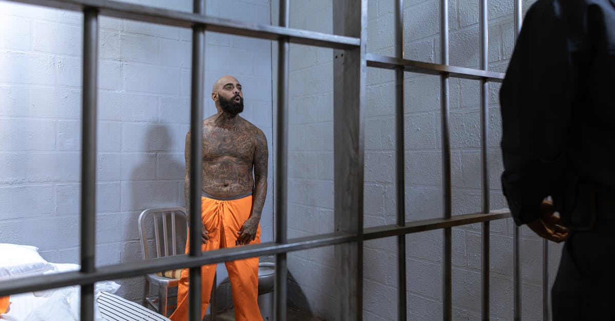 Australia eVisitor visa - criminal conviction - A Shirtless Prisoner Full of Body Tattoos