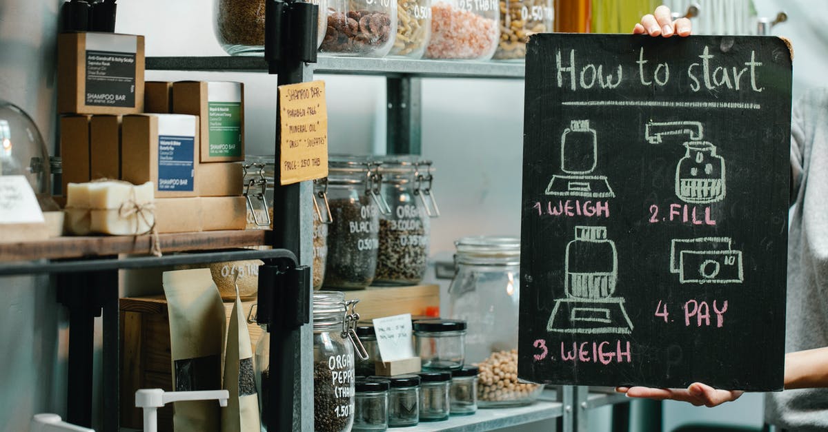 Australia: How to know price of goods in groceries - Assorted natural products and food in glass jars and paper packages on shelves in self service eco shop