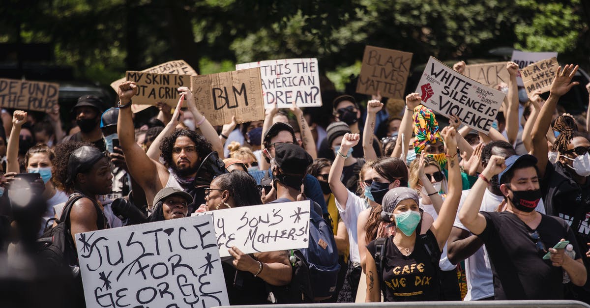 Australian living in Canada, USA Visa Waiver Program? - Crowd of Protesters Holding Signs