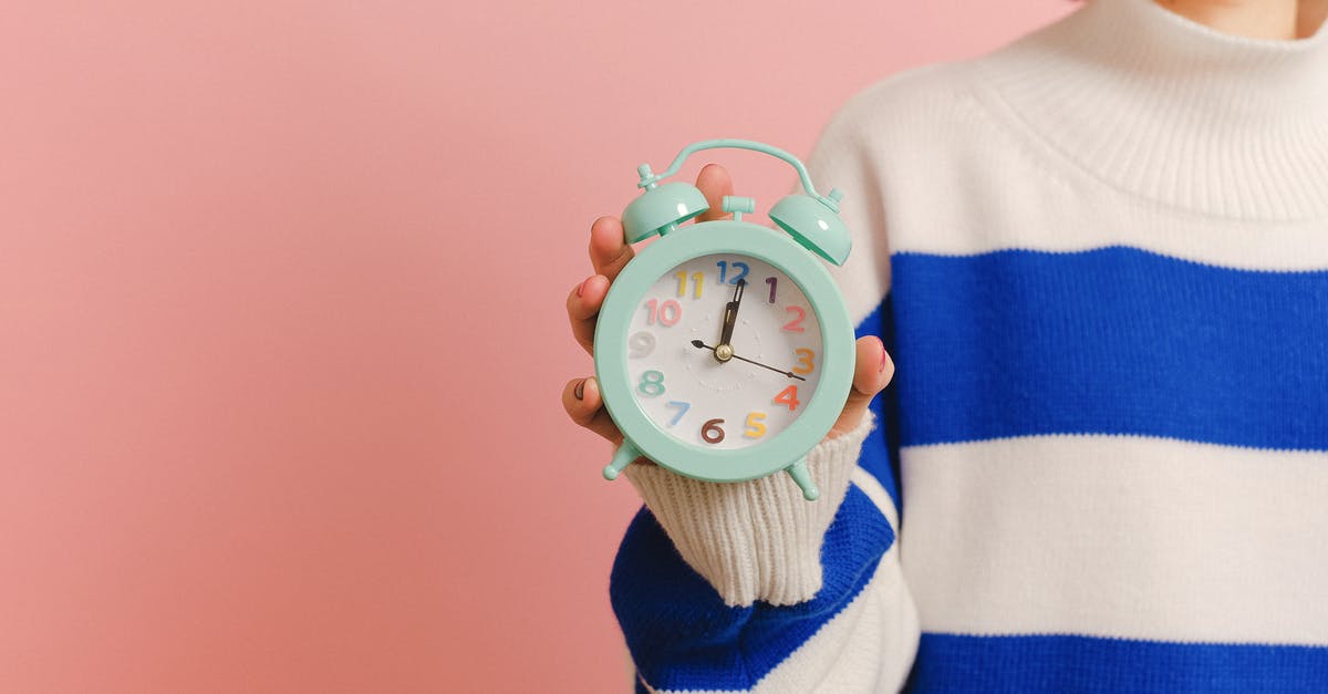 Australian passport processing time overseas - White and Pink Analog Alarm Clock at 10 10