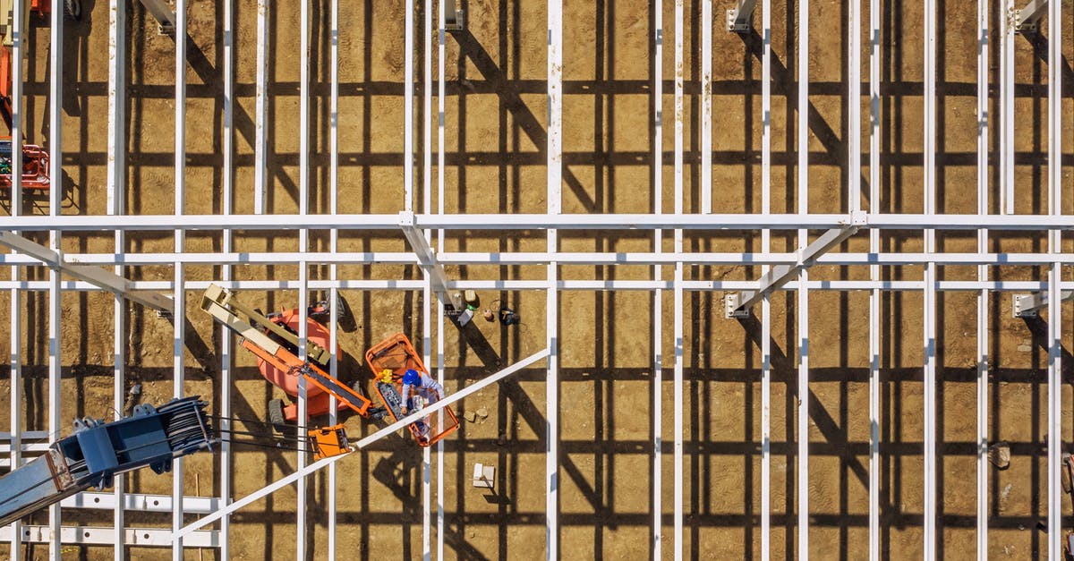 Automated passport control in the EU - Top view of mechanical machines providing frame of future building in sandy quarry on sunny day