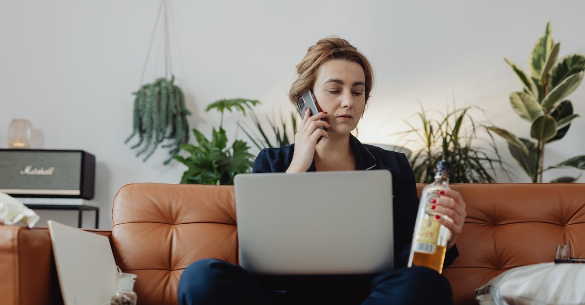 Availability of alcohol in Morocco? - Woman Talking on the Phone and Holding a Bottle of Liquor 