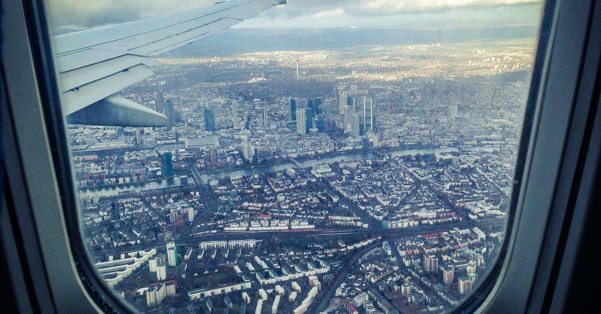 Avoid getting sick when traveling by plane - Airplane Windowpane Showing City Buildings