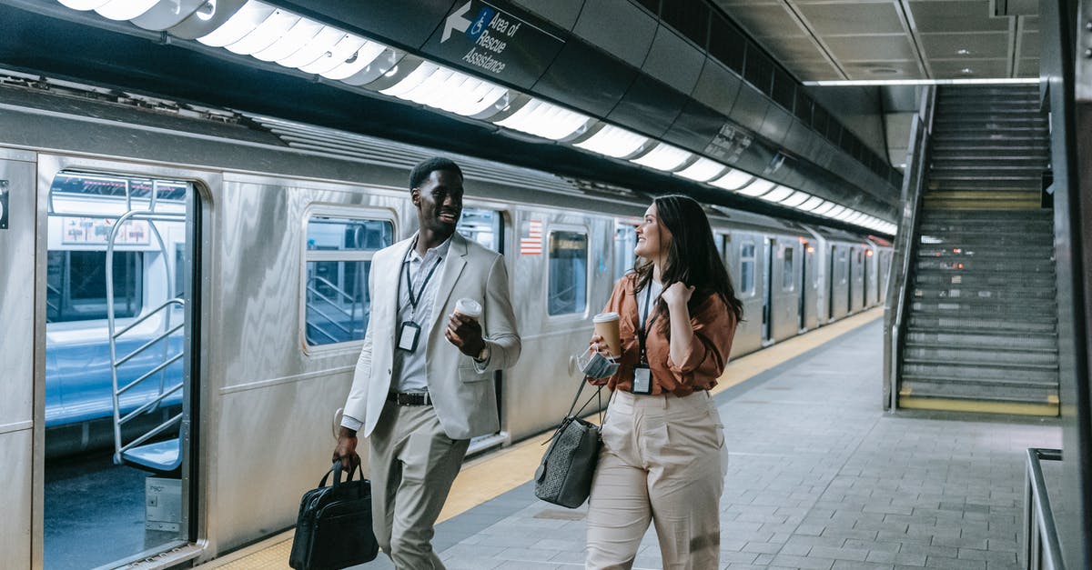 Avoid long walking when changing between Tokyo subway lines - A Man and Woman Walking Near the Train while Having Conversation