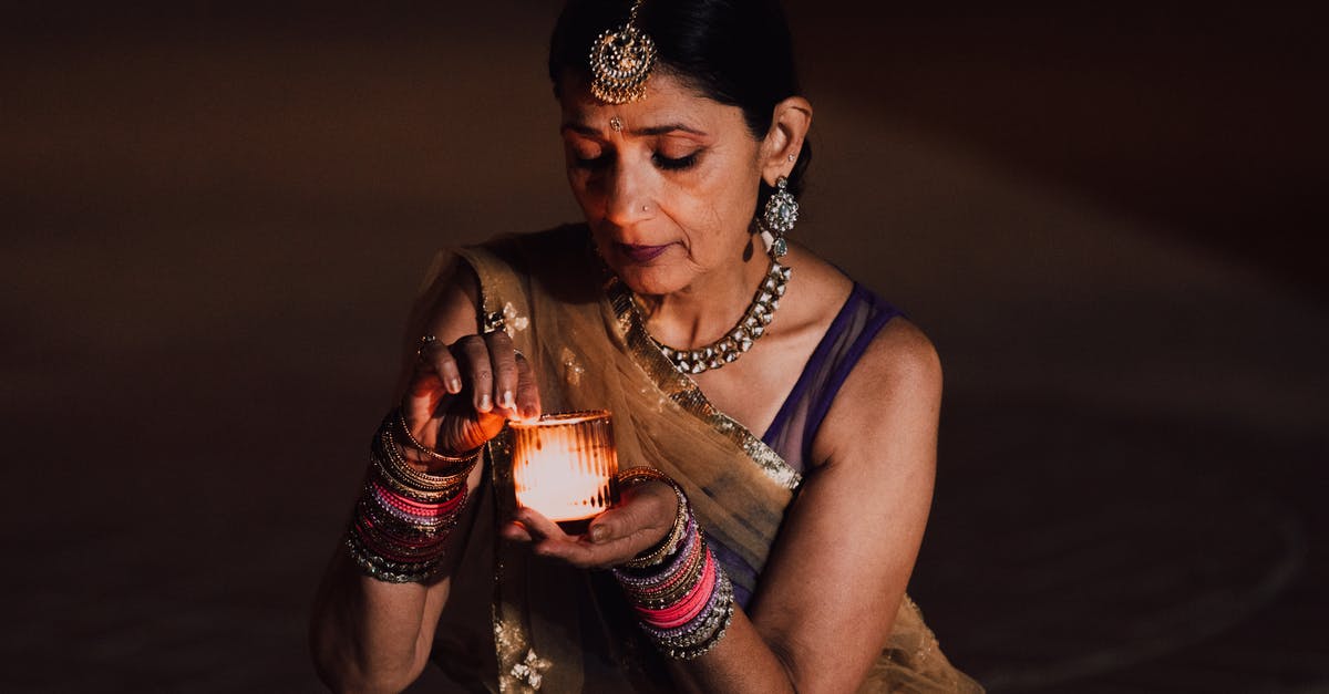 Avoid racism in India towards fellow Indians [closed] - A Woman in Traditional Clothing Holding a Lit Candle