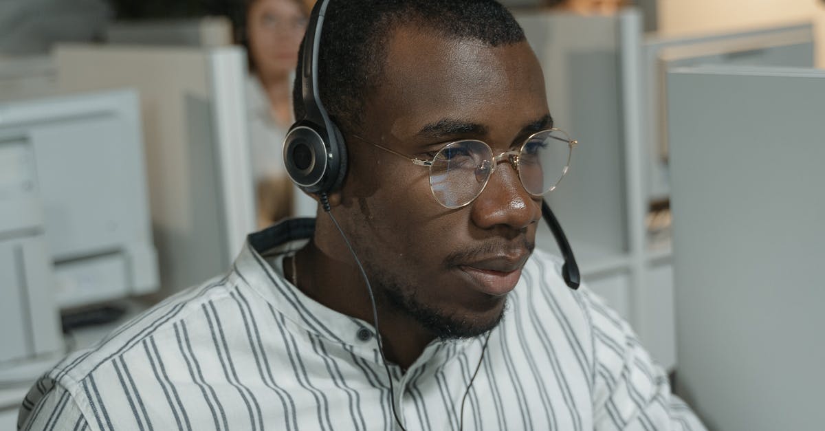 B1/b2 visa both travelling and working [closed] - Man in White and Black Striped Button Up Shirt Wearing Black Headphones