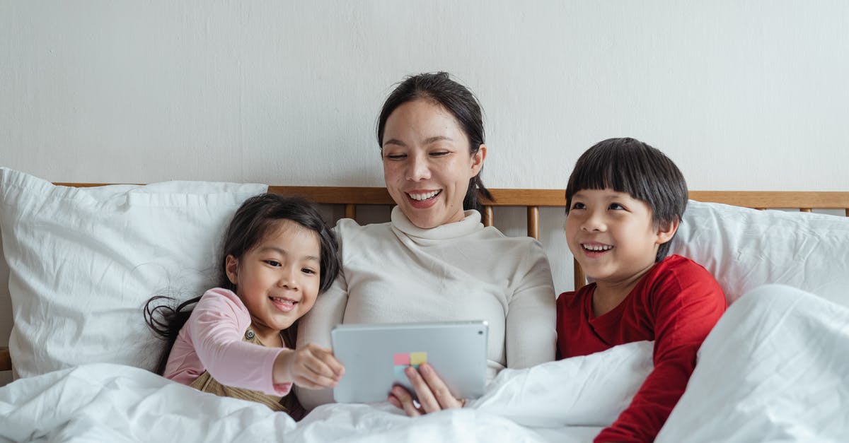 B2 visa extension online for parents [closed] - Positive ethnic mother and little children using tablet in bed