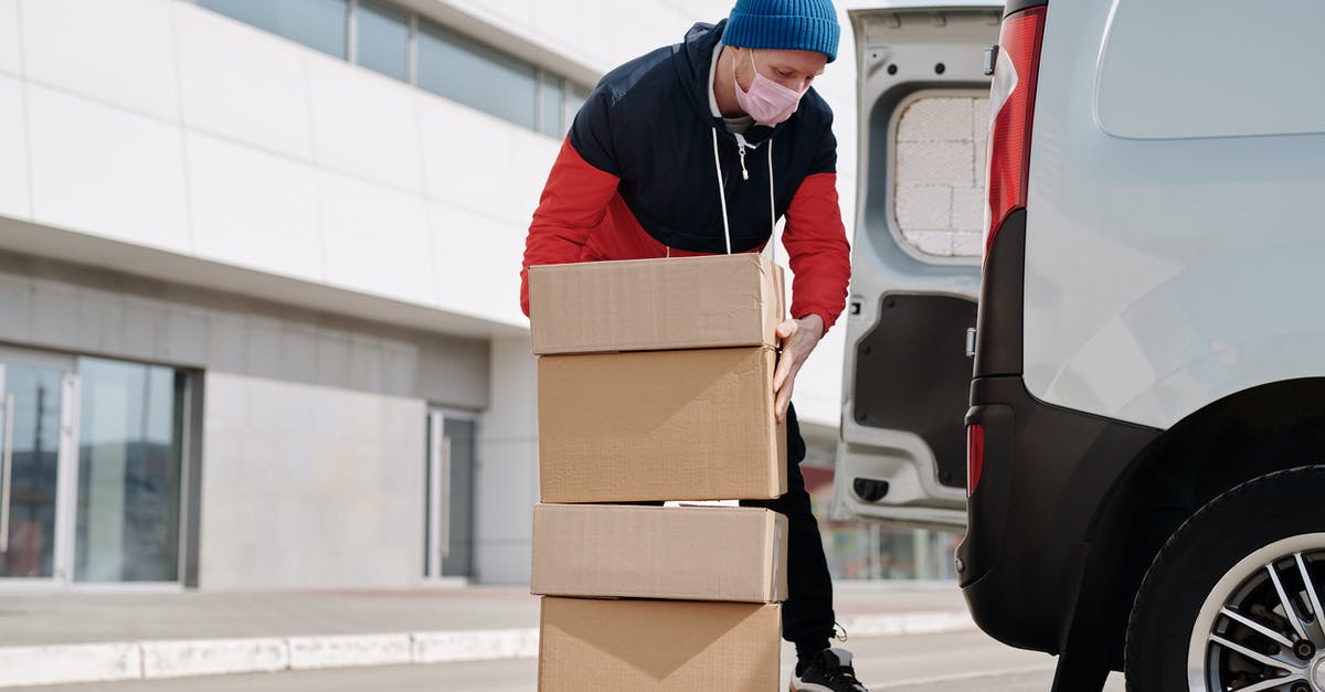 B-2 Visa, re-entry (with existing ESTA) - Delivery Man Wearing a Face Mask Carrying Boxes