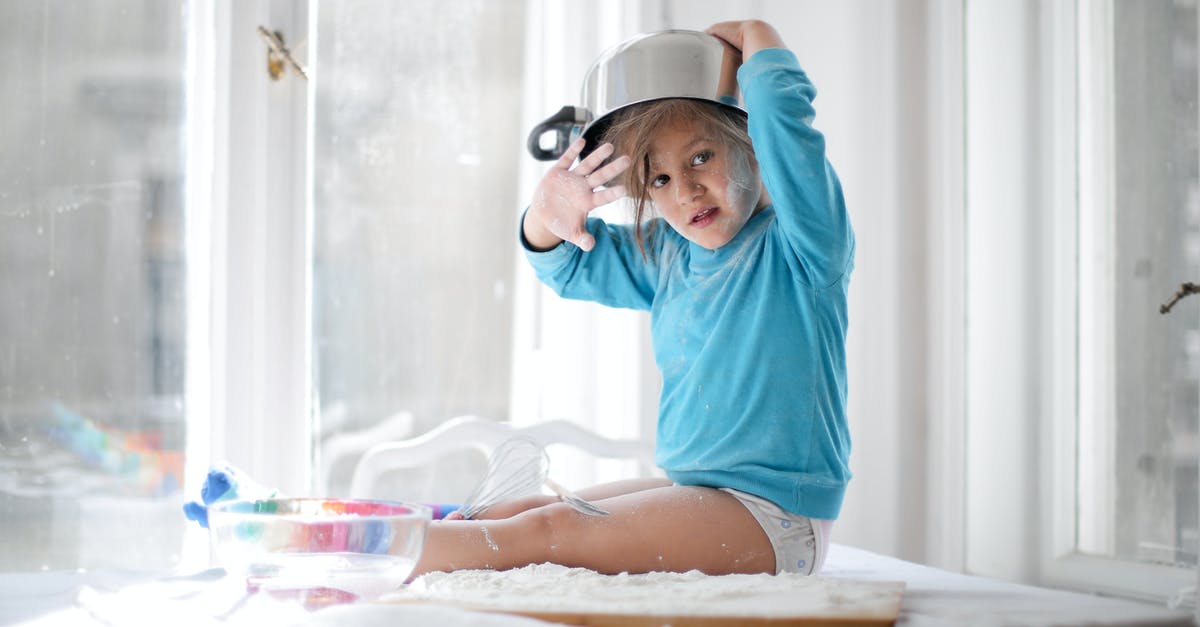 Baby food in checked bags? - Little girl playing with pan and flour in kitchen