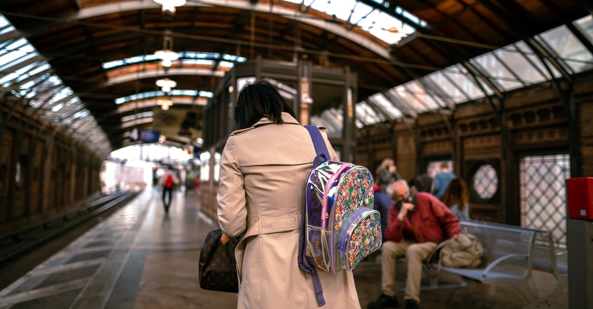 Back to back single entry visa passport stamping - Woman in Brown Coat Standing on Train Station