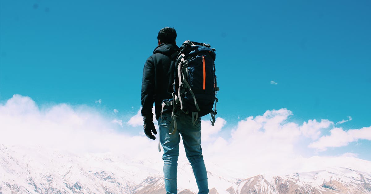 Backpack or Tote Bag: Which is a better personal item? [closed] - Photo of Man Standing On Top Of Mountain