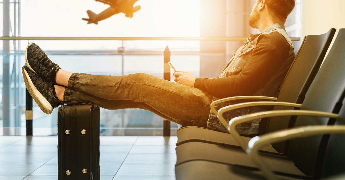 Baggage and check-ins on different airlines - Man in airport waiting for boarding on plane