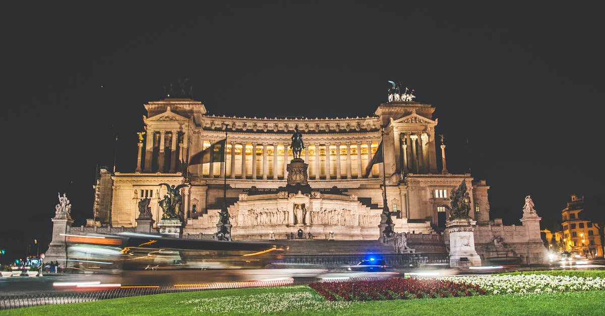 Baggage fees on Delta, Europe - Central America, with a long stopover - Exterior of Victor Emmanuel II National Monument or Vittoriano located in Rome in Italy at night with green grass and flowers nearby