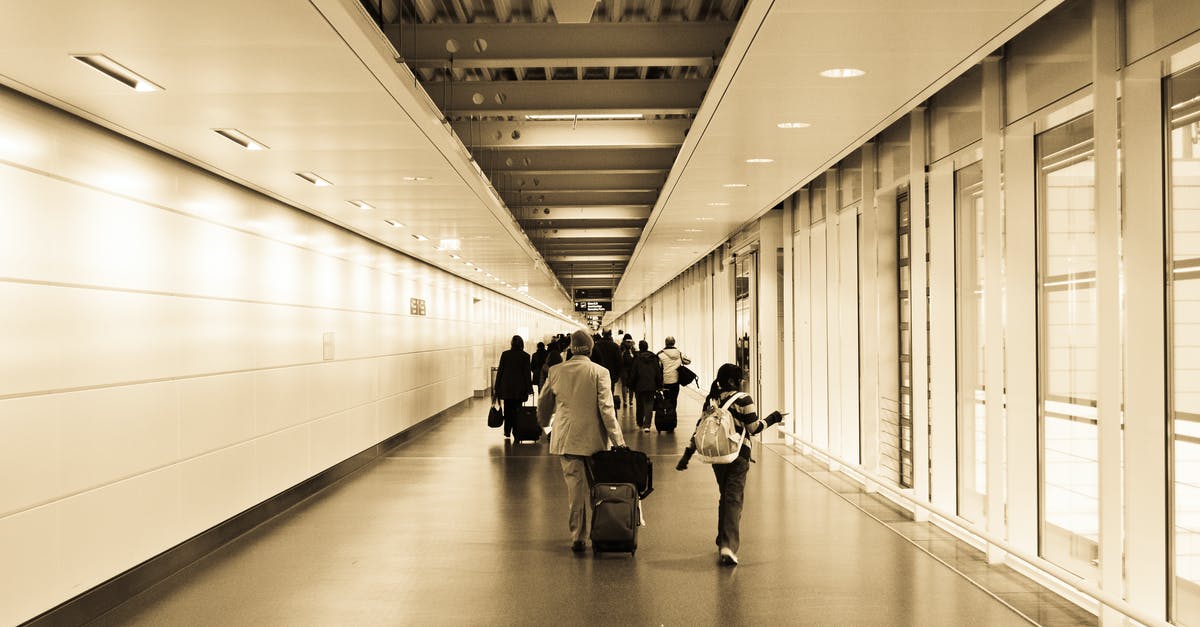 Baggage movement help at Seattle airport - People Walking in the Hallway Inside the Building