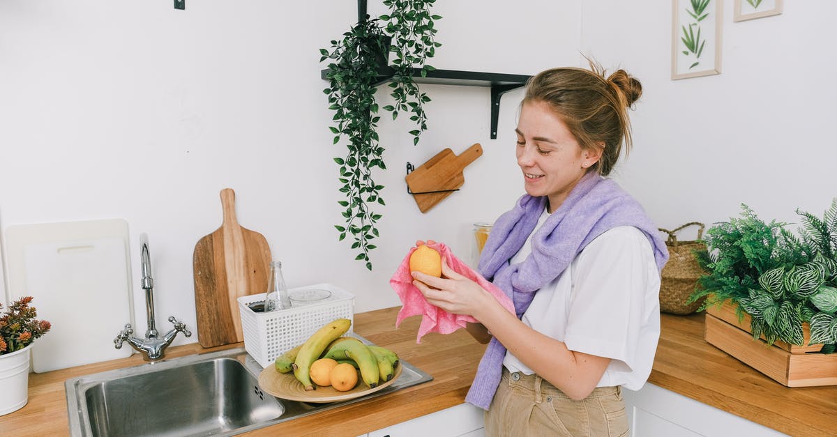 Banana hammock on a domestic US flight? [closed] - Smiling female cleaning fruits in light kitchen