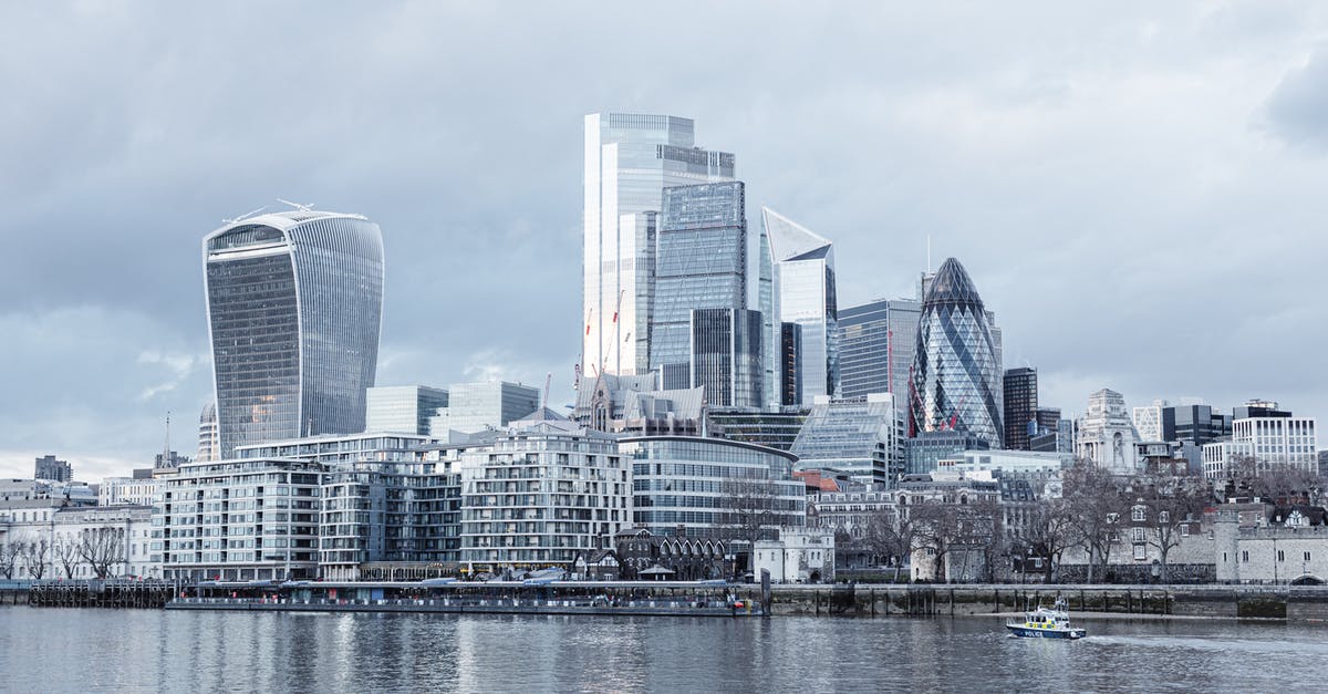 Bank statement for UK visa - Contemporary multistory high rise business centers located on embankment with trees near Thames river in London city