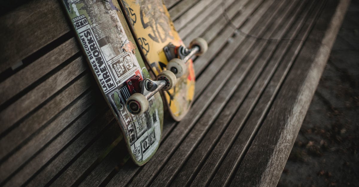 Barbecuing in a public park in Athens - Boards with rollers for skateboarding placed on wooden bench in park in daylight