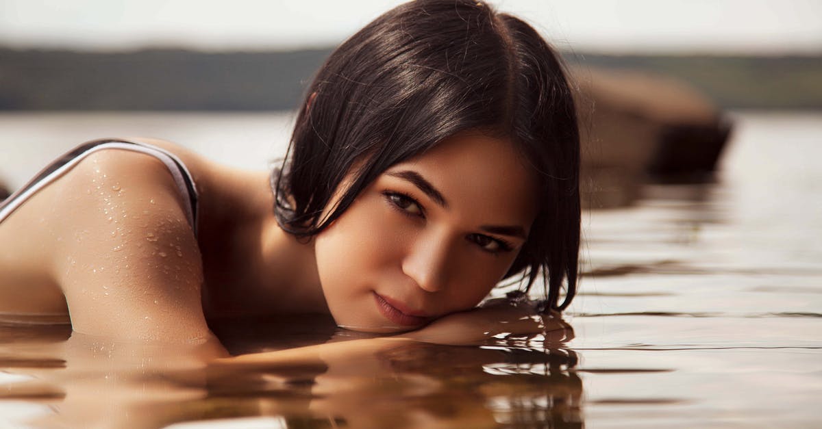 Beaches near Amsterdam [closed] - Brunette Woman Lying on Front in Shallow Water 