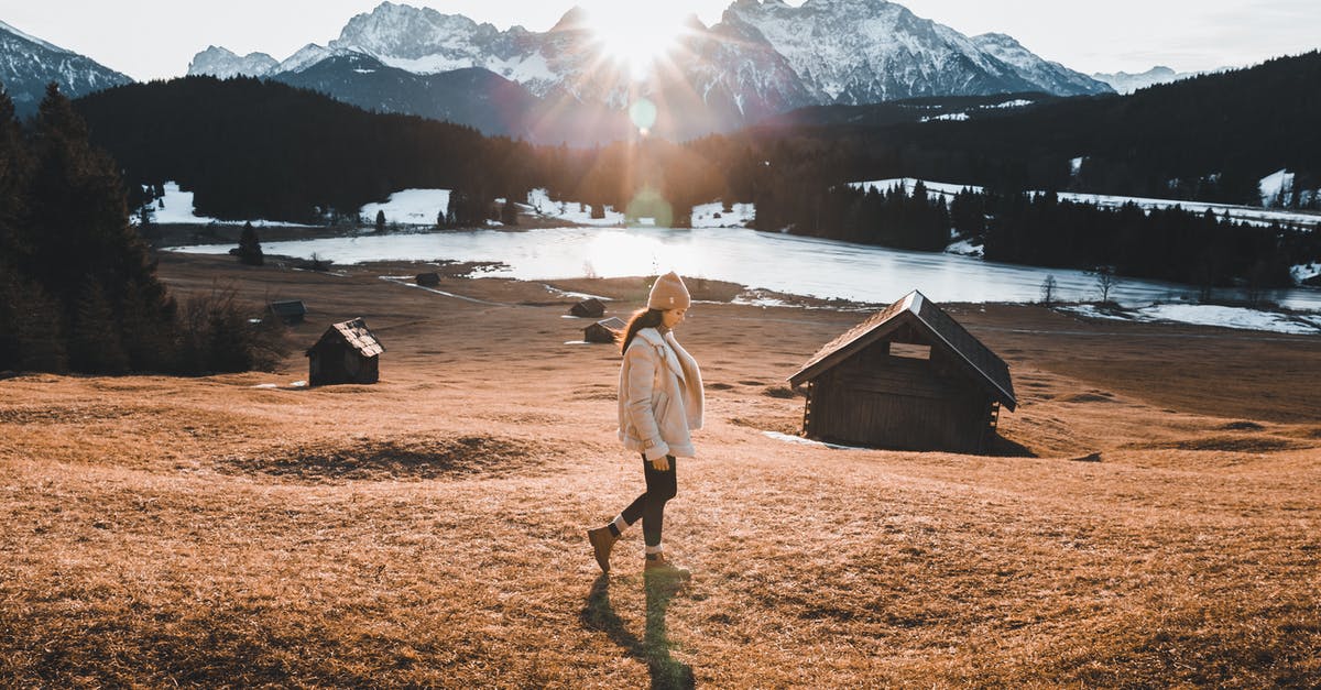 Beaches on lakes in Germany - security aspects - Woman in Brown Coat Standing on Brown Grass Field Near Body of Water