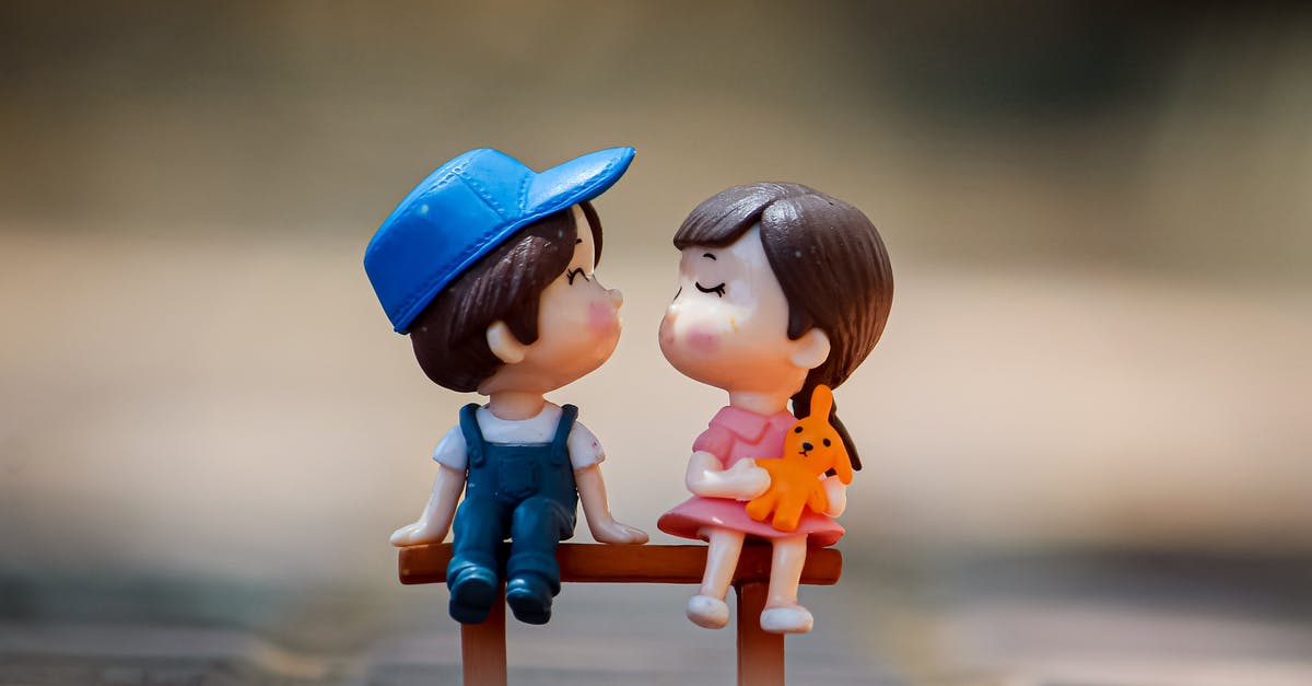 Belize with two small children [closed] - Tiny figurine of cute little girl and boy sitting on bench together and kissing