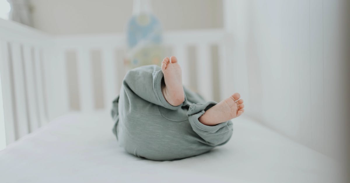 Below standard baby crib - Close-up Photo of Baby Wearing Gray Pants