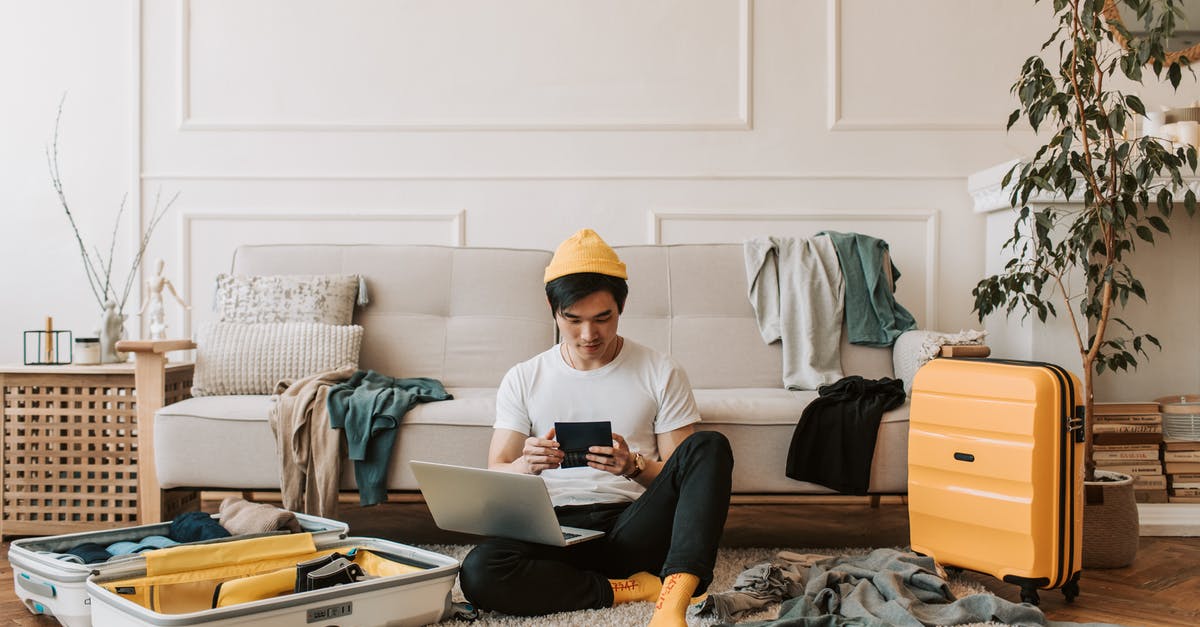 Benefits of checking in online when checking bags - A Man Using His Laptop in a Messy Living Room