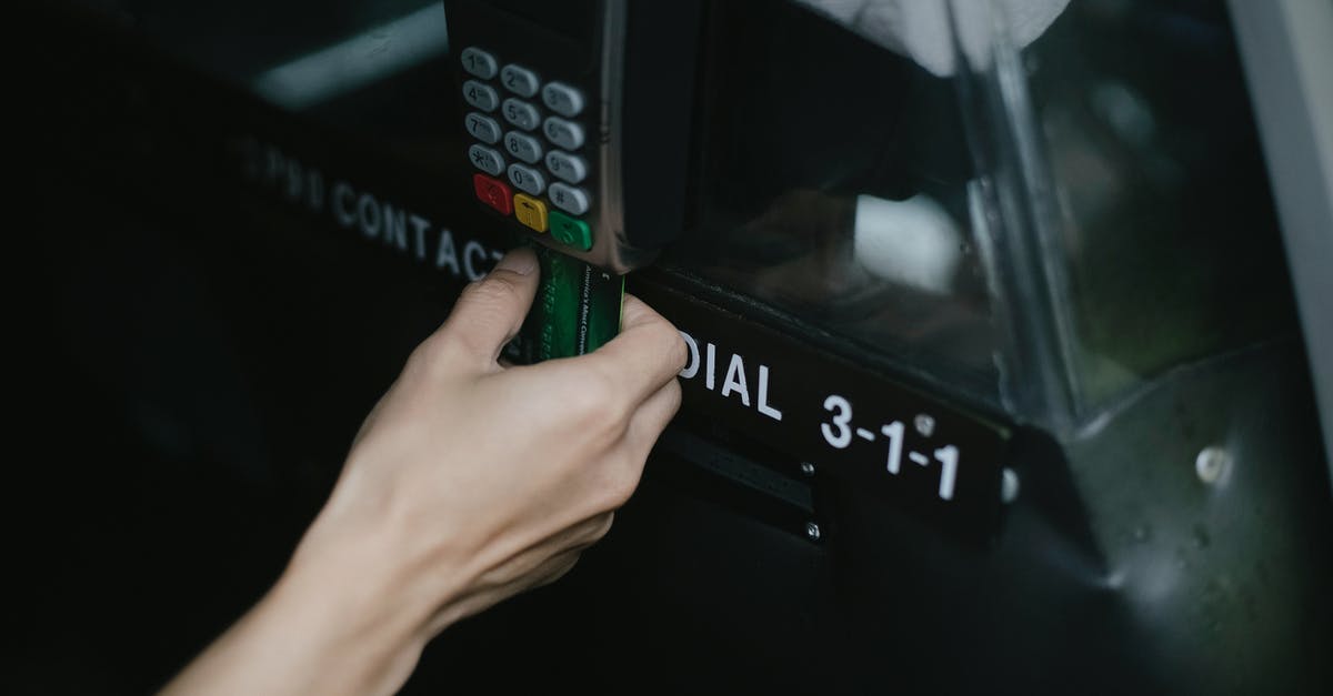 Berlin: Pay per use travel card for public transport - Crop anonymous traveler using card device while paying for taxi ride in automobile