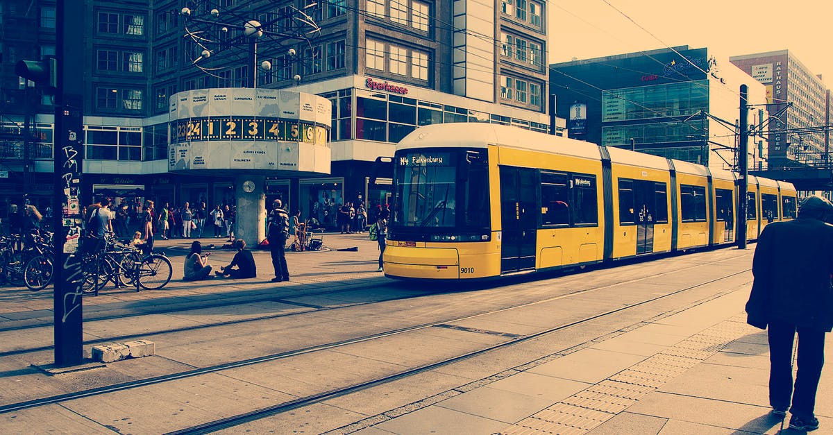 Berlin public transport apps (similar to jakdojade) - Selective Color Photography of Yellow Train Near Concrete Buildings