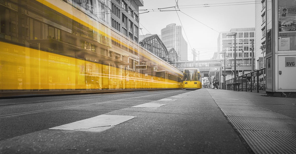 Berlin to Munich in 5 Days [closed] - Selective Color Photography of Yellow Train Beside Building