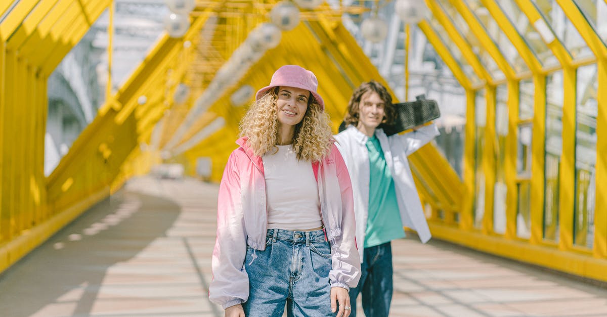 Best jacket for Sweden? [closed] - Woman in White Long Sleeve Shirt and Blue Denim Shorts Standing on Wooden Bridge