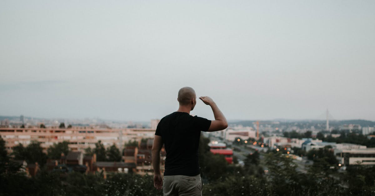 Best place to view the Northern Lights [closed] - Man Looking Towards the City