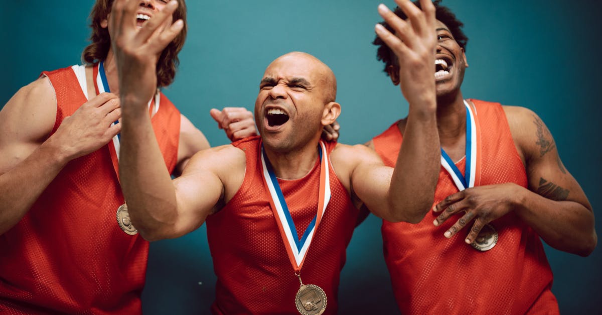 Best places in India to visit in September first half [closed] - Overjoyed Men in Red Jerseys Wearing Their Medals