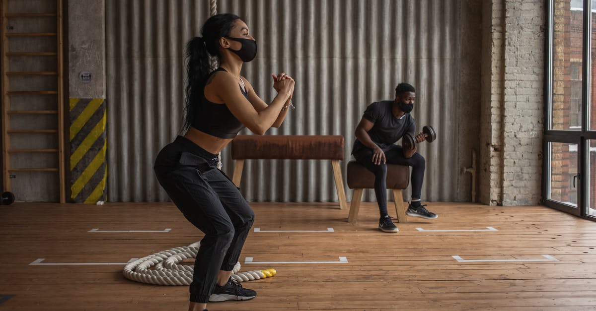 Best practice for managing Covid vaccination documentation - Black sportspeople in fabric masks working out in gym