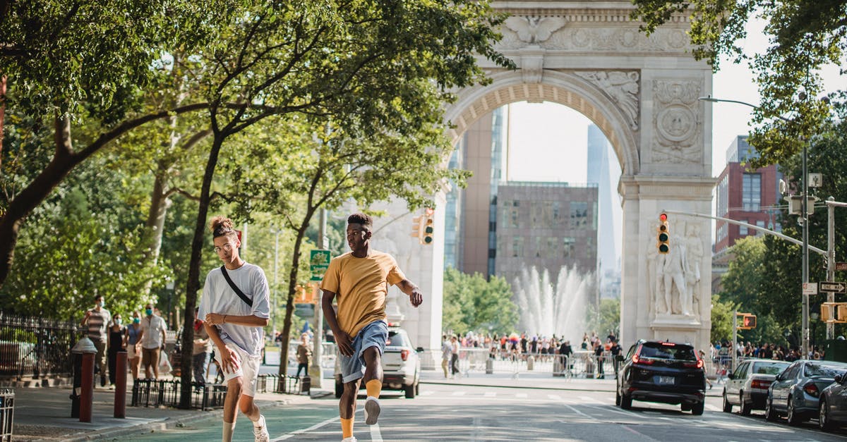 Best practice to apply for US Family/Group Visa - Trendy diverse male teens skateboarding on city street in sunlight