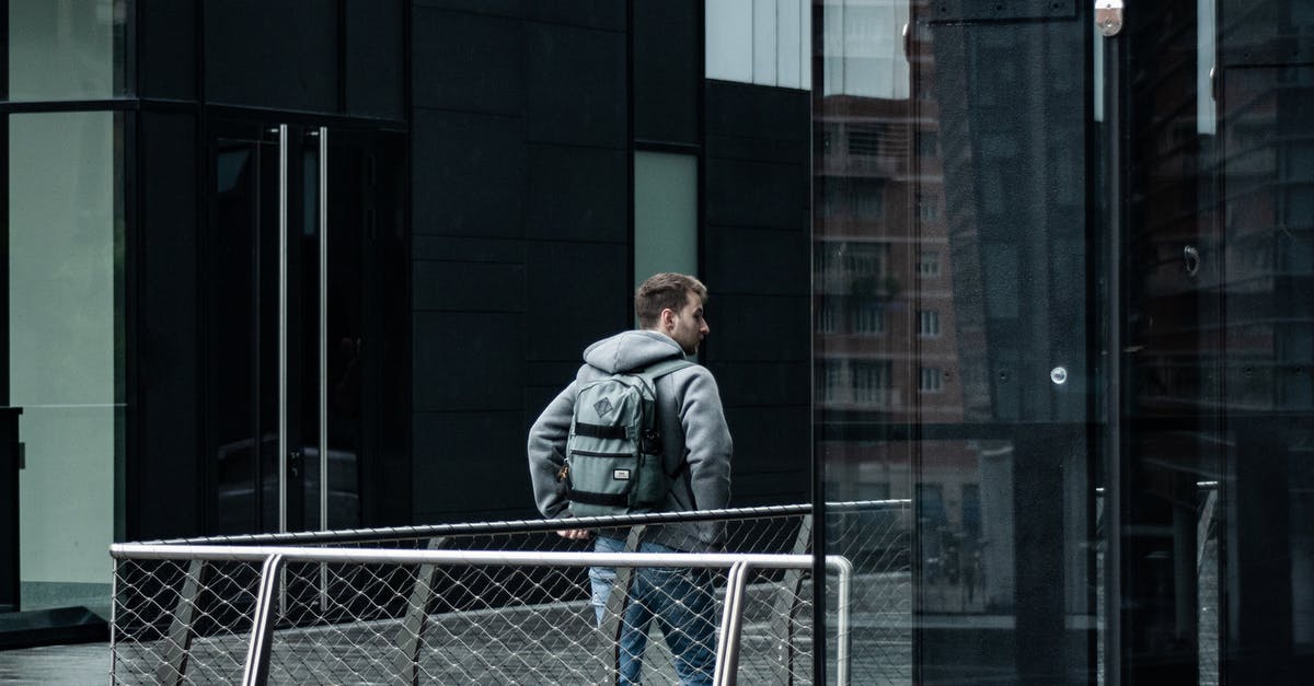 Best Rail Pass for Italy - Photo of Man Walking Near Buildings