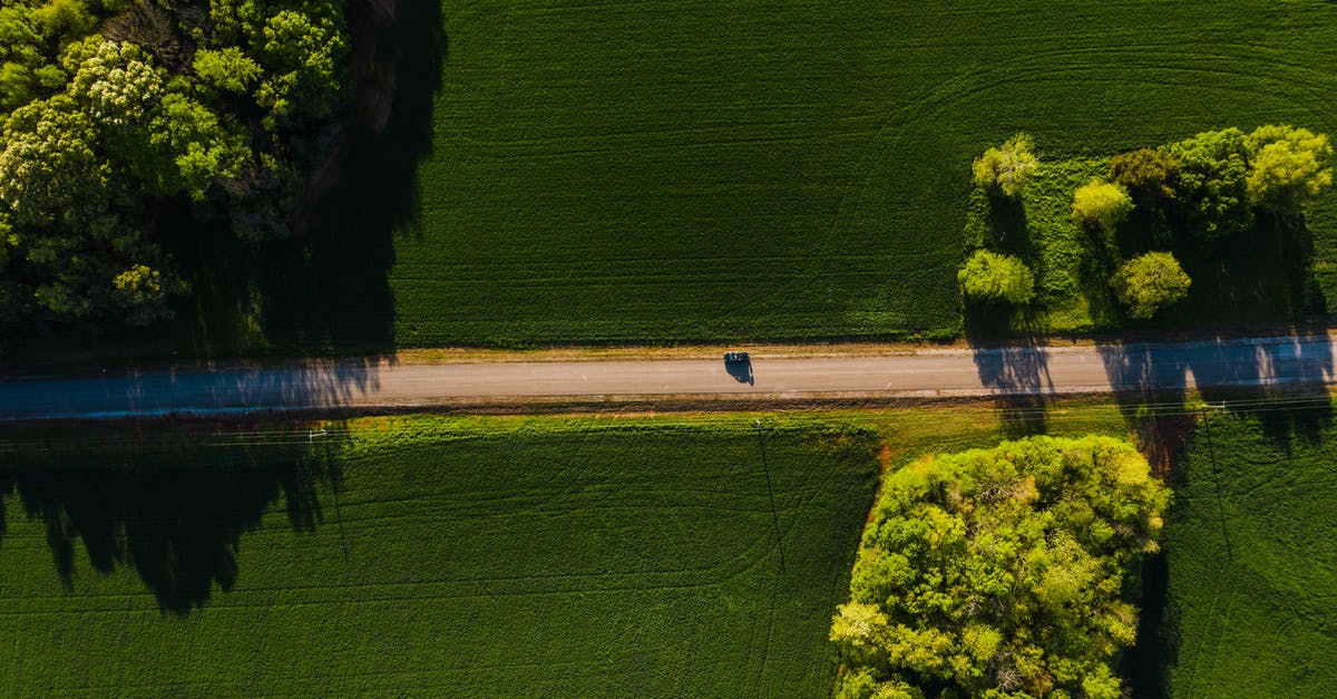 Best road route from Córdoba to Mendoza, Argentina? - Car driving through green fields on sunny day