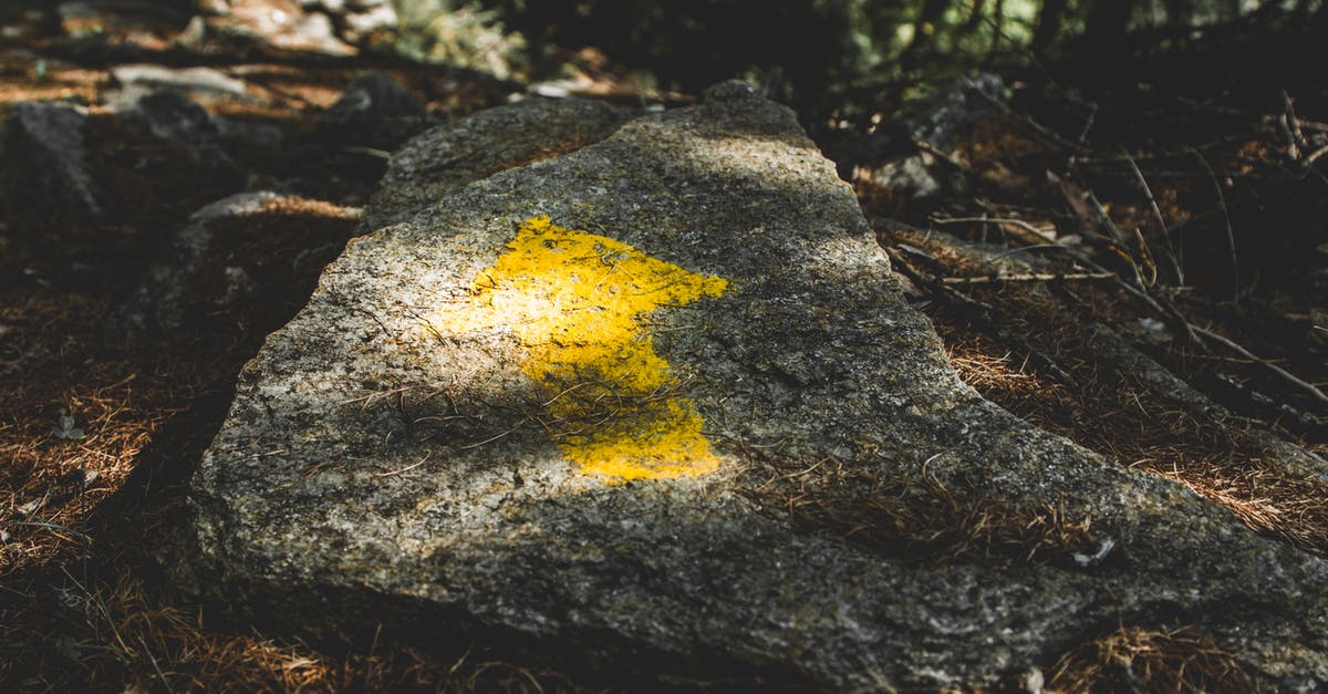 Best Way of Travelling Weekly [closed] - Yellow Arrow Painted on Gray Stone