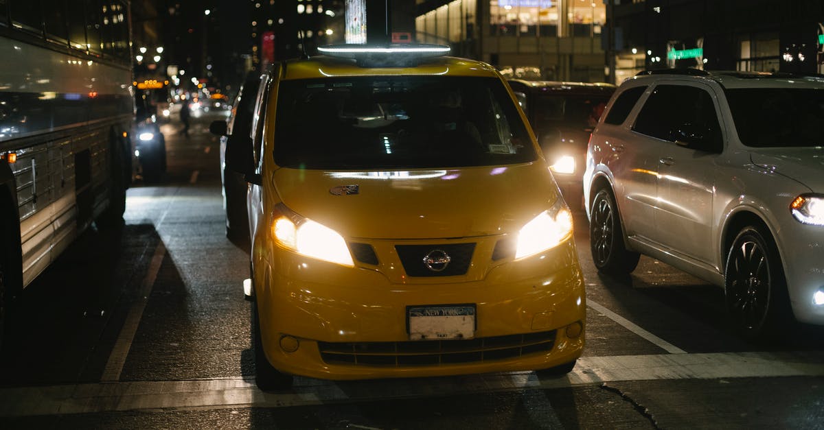 Best way to do one-way car rentals in the US - Shiny cab and automobiles driving on night city street