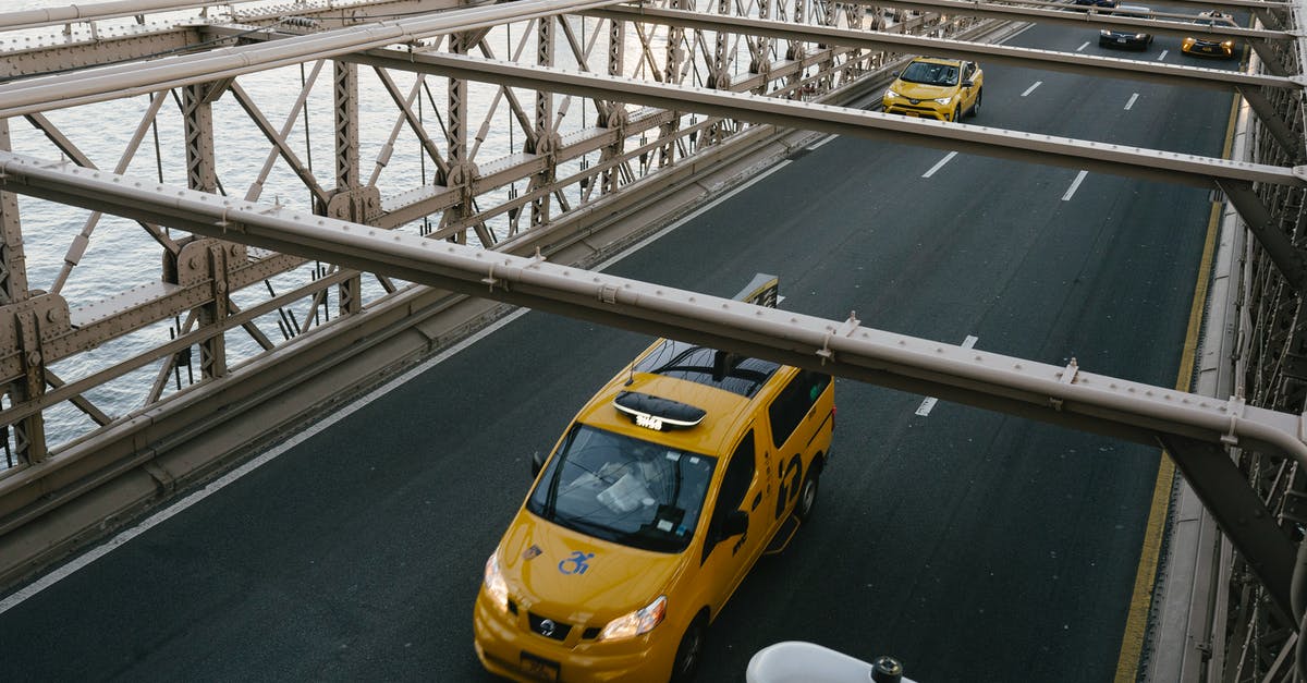 Best way to do one-way car rentals in the US - Taxi cabs driving on suspension bridge