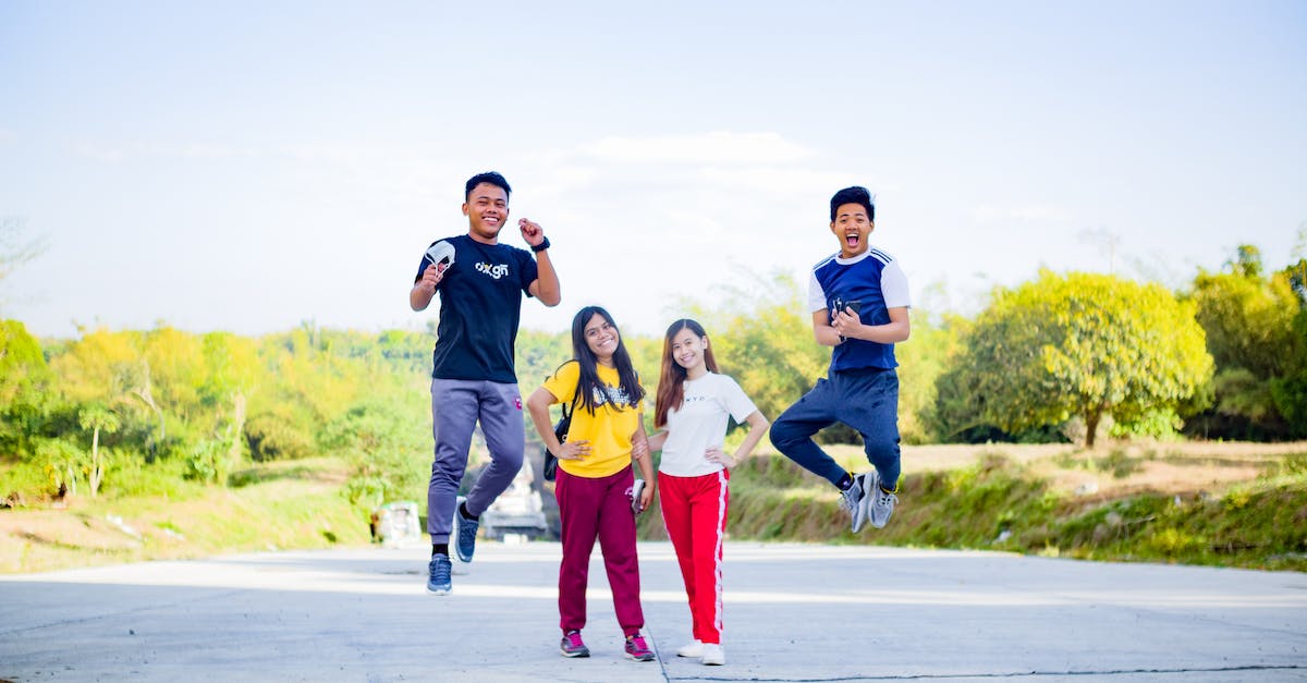 Best way to make my ears pop? - Happy Asian friends having fun together in park