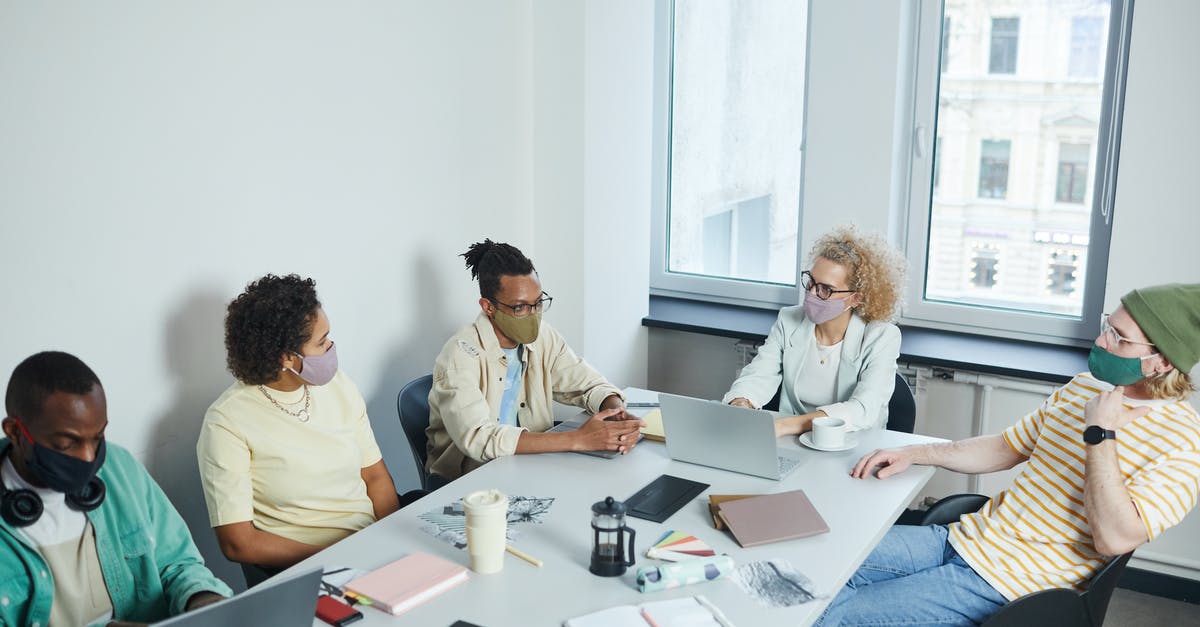 BI/B2 Visa status covid-19 - 3 Men Sitting at Table