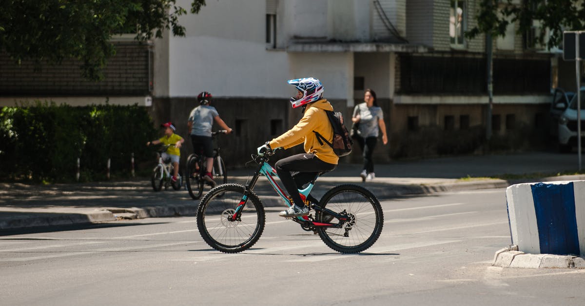 Bicycle helmet and backpack as carry-on in the US? - Unrecognizable biker riding bicycle on city road