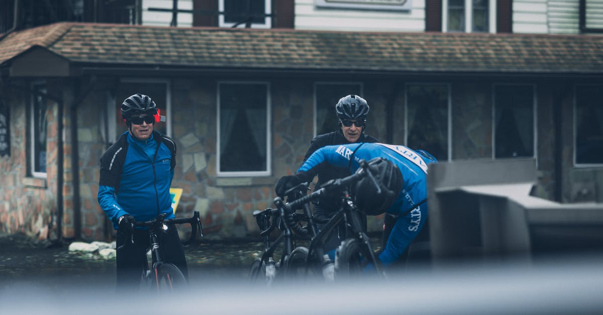 Bicycle Helmets with Bike Rental in Amsterdam? - Two Man Riding Black Mountain Bikes