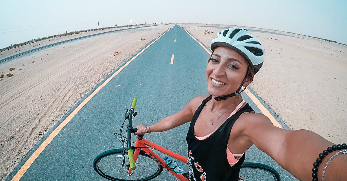 Bicycling routes in Śląskie/Małopolskie - Woman Holding Bicycle on Asphalt Road